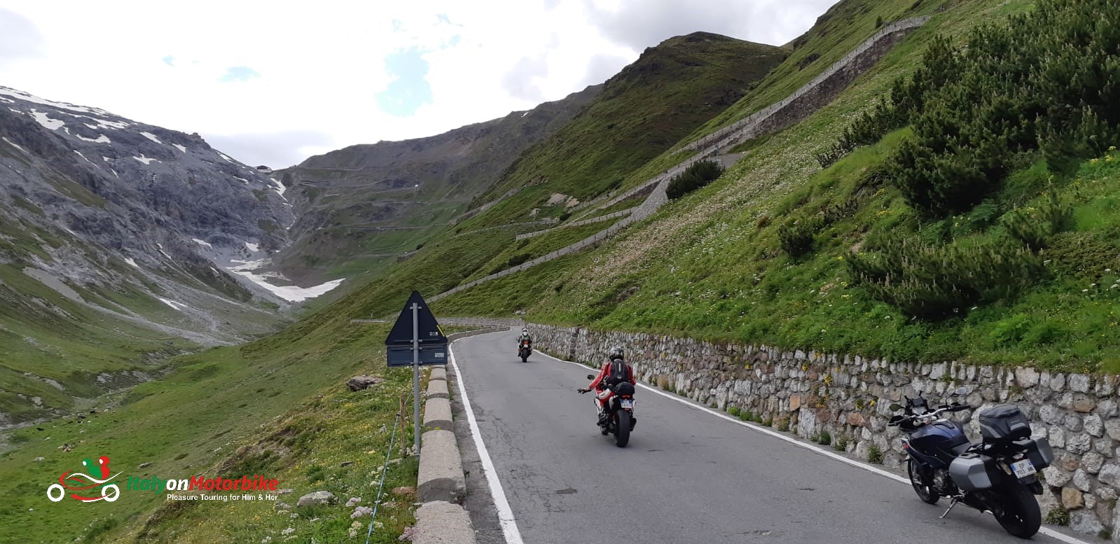 Biker's salute at the bottom of the Stelvio pass on our motorcycle tour of the Alps